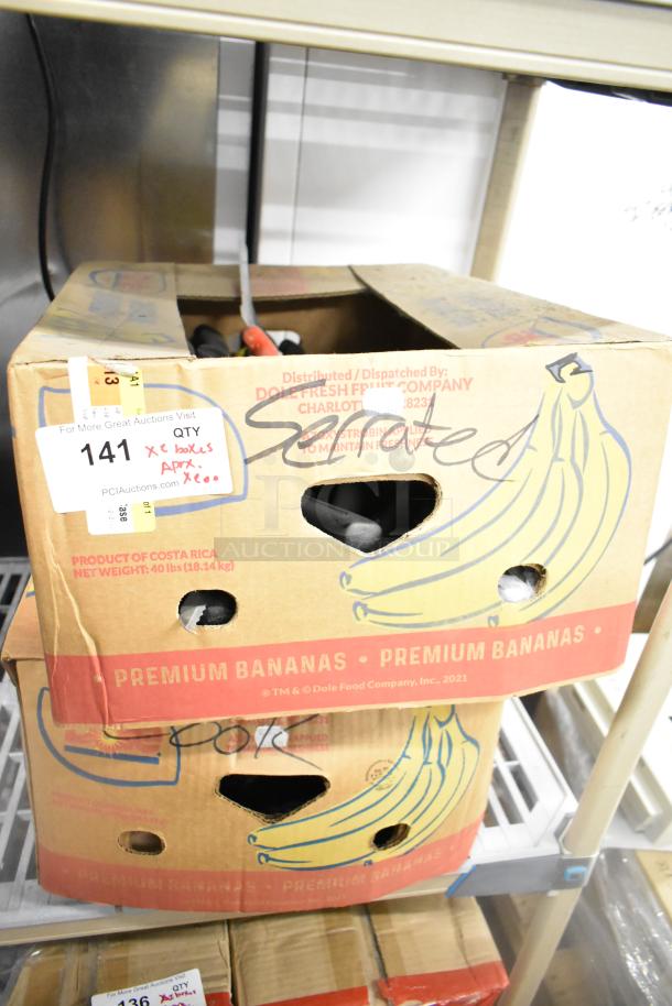 Box containing 200 sharpened stainless steel knives, including chef and serrated knives, stacked on shelf. Marked "Serrated."