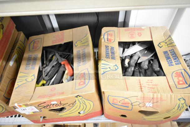 Two boxes containing 200 sharpened stainless steel knives, including chef and serrated knives. Auction item for bid.