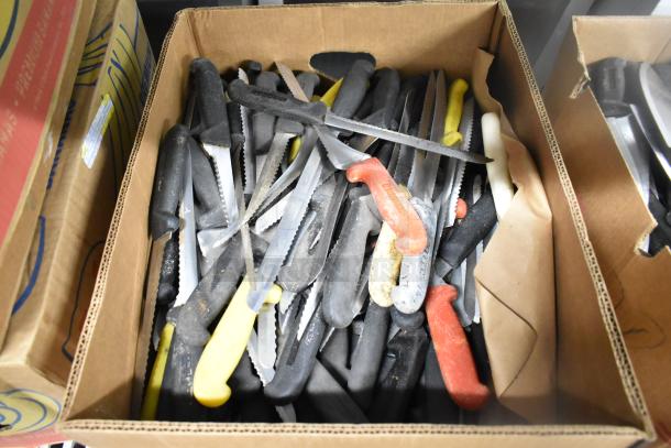 Box of 200 sharpened stainless steel knives, including chef and serrated types, various handle colors, used condition.