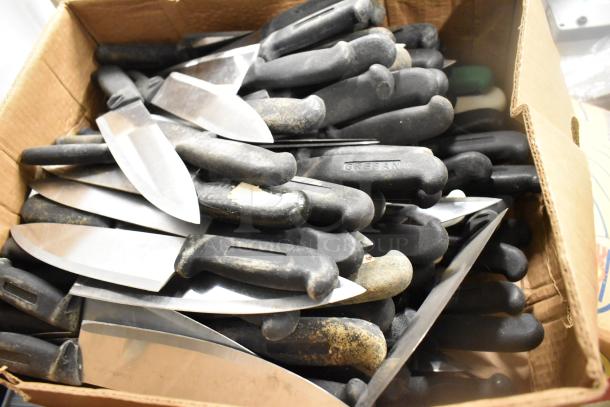 Box of 200 sharpened stainless steel knives, including chef and serrated knives, black handles marked "GREBAN."