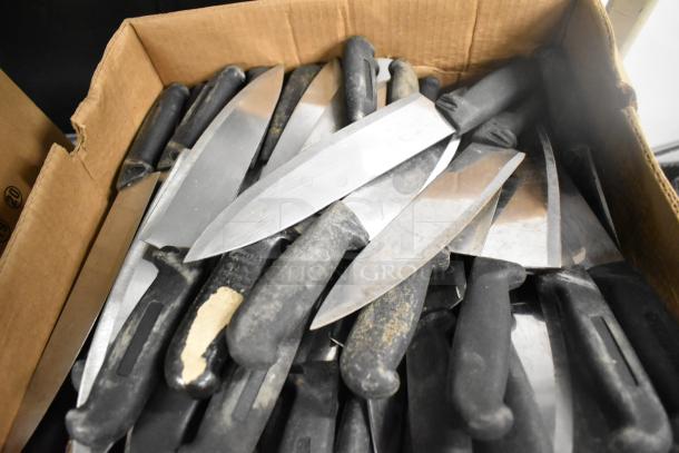 Box of 200 sharpened stainless steel knives, including chef and serrated knives. Various black handles, used condition.