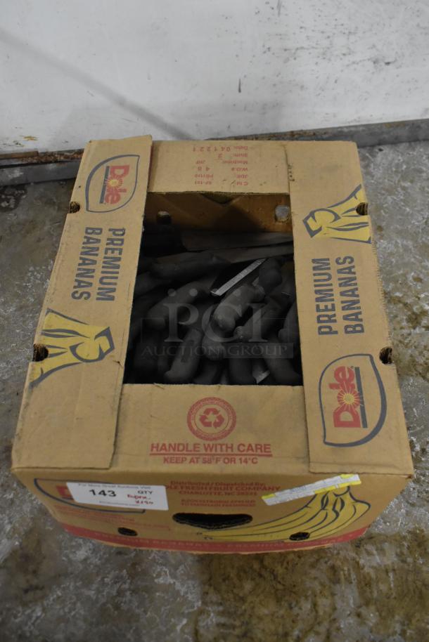 Box containing 150 sharpened stainless steel knives, including chef knives. Labeled with "Premium Bananas" and "Handle With Care."