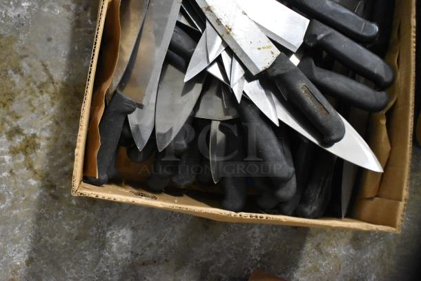 Box of 150 sharpened stainless steel knives with black handles, including a chef knife. Suitable for culinary use.