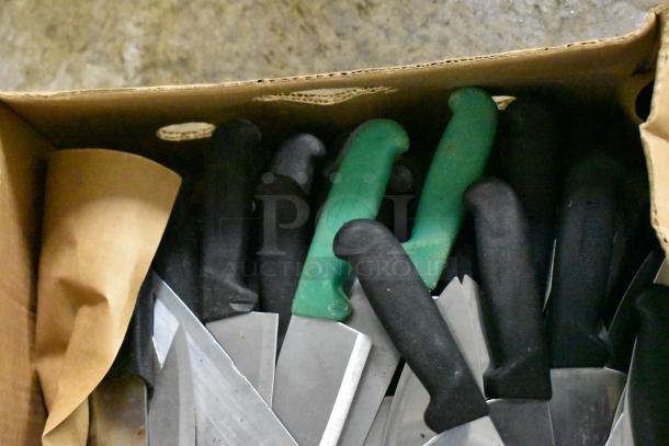 Box of 150 sharpened stainless steel knives, including chef knives, with black and green handles. Auction item.