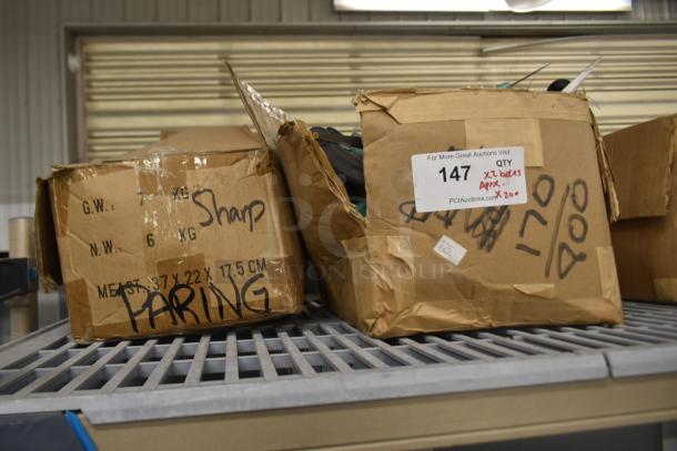 Two boxes of sharpened stainless steel knives, including poultry and paring knives, 200 pieces, marked "Sharp" and "Paring."