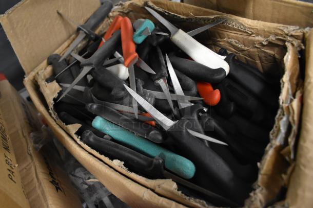 Box of 200 sharpened stainless steel knives, including poultry and paring knives, with assorted handle colors.