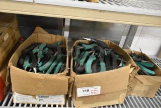 Boxes of 250 sharpened stainless steel knives with green and black handles, including poultry knives.