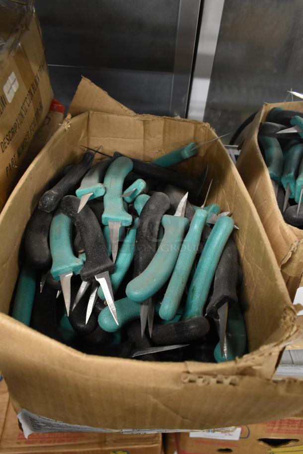 Box of 250 sharpened stainless steel knives with teal and black handles, including a poultry knife, in good condition.