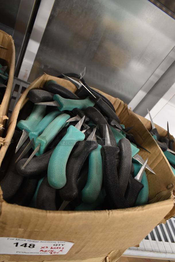 Box of 250 sharpened stainless steel knives with teal and black handles, including a poultry knife, shown in good condition.