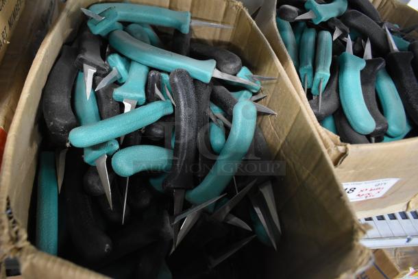 Boxes of 250 sharpened stainless steel knives with teal and black handles, including poultry knife.