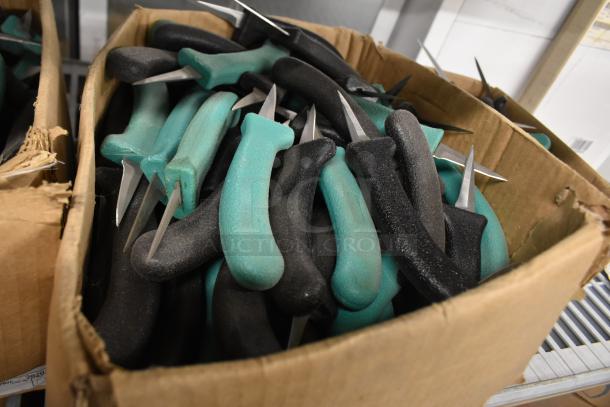 Box of 250 sharpened stainless steel knives with teal and black handles, including a poultry knife, in new condition.