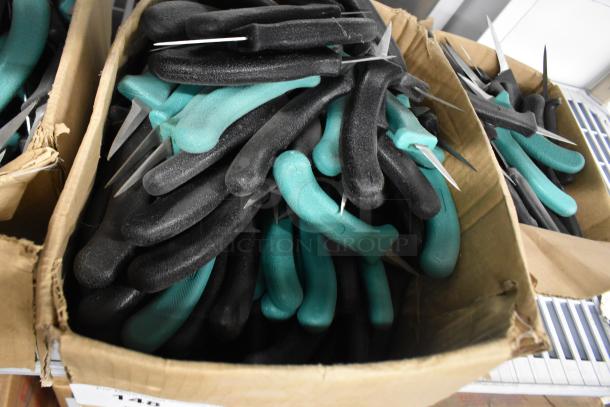 Boxes of 250 sharpened stainless steel knives with black and teal handles, including a poultry knife.