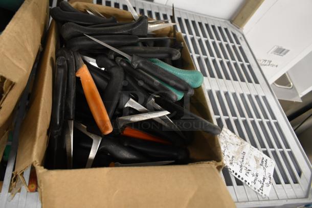 Box of assorted stainless steel knives, including black, orange, and green handles. Includes poultry knife. All sharpened.