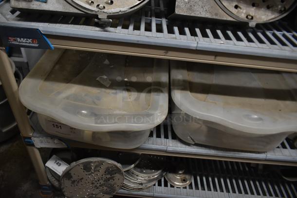 Two bins of various ice cream machine parts, including augers and front panel, on a shelf. Inventory labels visible.