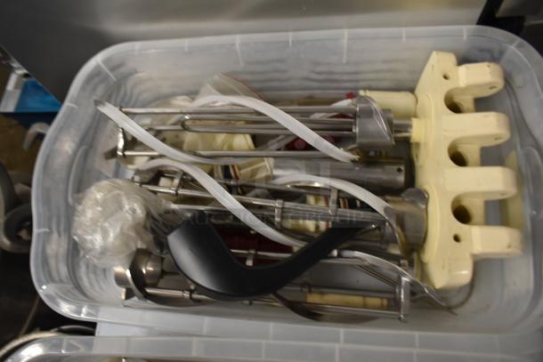 Two bins containing various ice cream machine parts, including augers and a front panel, in good condition.