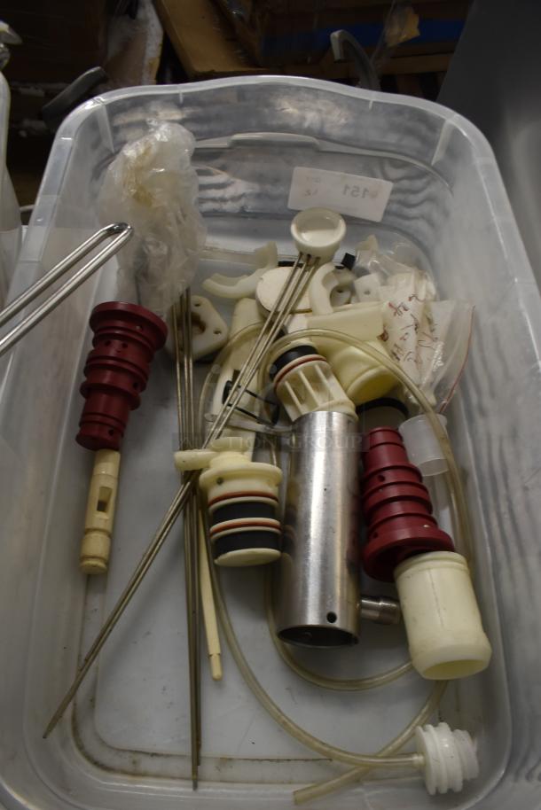 Two bins of assorted ice cream machine parts, including augers and front panel, in good condition, some in original packaging.