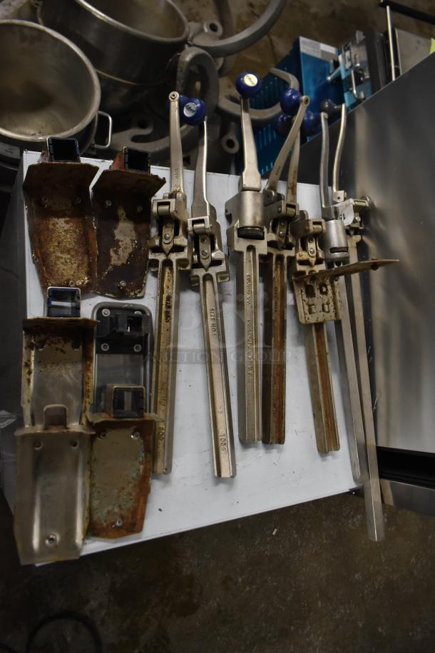 Seven commercial can openers with mounts, varying conditions. Brands include Edlund and Morrill. Visible rust on mounts.