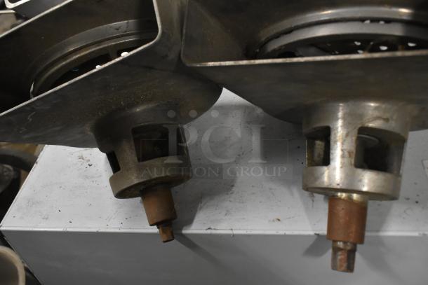 Four Pelican heads with blades, two grating and two slicing, without front pieces, in used condition.