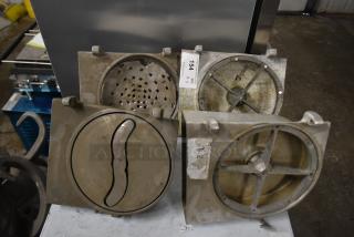 4 Pelican heads with 2 blades for grating and slicing, without front pieces. Visible auction tag and markings. Used condition.