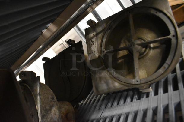 Four pelican heads with two blades for grating and slicing. No front pieces. Visible wear. Includes auction tag "382".