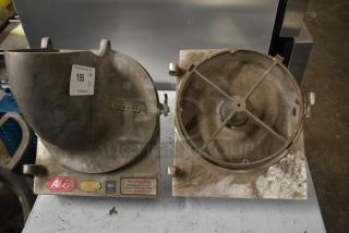 Two Hobart pelican heads with slicing blade frame, one missing front piece and blade, shows wear, safety labels visible.