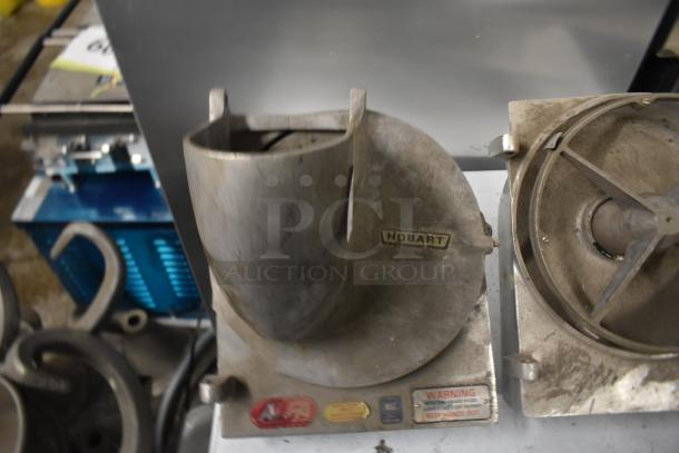 Hobart pelican heads with slicing blade and blade frame. One missing front piece and blade. Worn condition with visible labels.