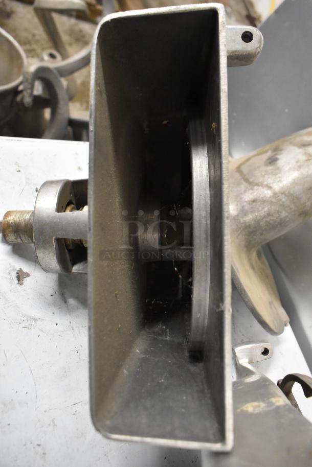 Two pelican heads with slicing blade and blade frame. One unit missing front piece and blade. Used condition.