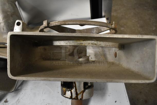 Two Pelican heads with slicing blade and frame, one missing front piece and blade, metal finish, used condition.