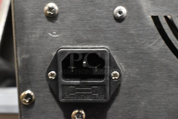 Close-up of power socket on Avantco 177LT06A stainless steel food dehydrator. Scratch and dent item; only works on high heat setting.