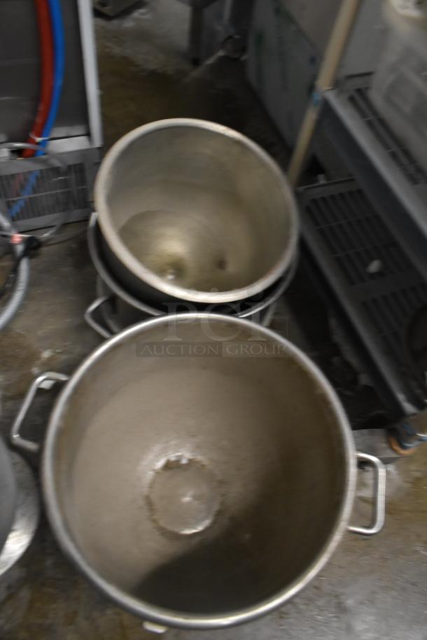 Three large metal mixing bowls stacked, designed for Hobart mixers. Visible handles, showing signs of use.