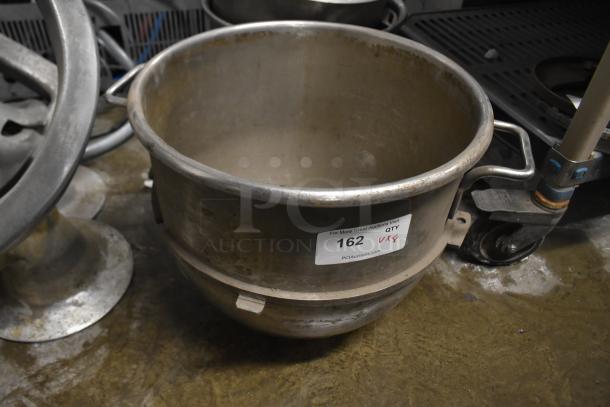 Set of 8 items includes 3 metal mixing bowls and 5 dough hooks for Hobart mixer. Bowl has visible wear. Auction lot #162.