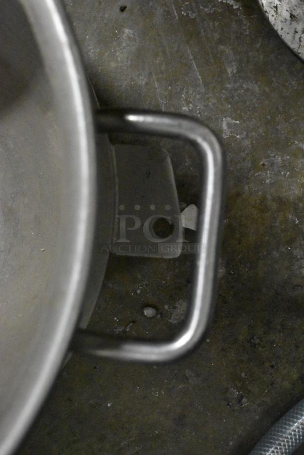 Stainless steel mixing bowl handle on a metal surface, part of an auction lot with 3 bowls, 5 Hobart dough hooks.