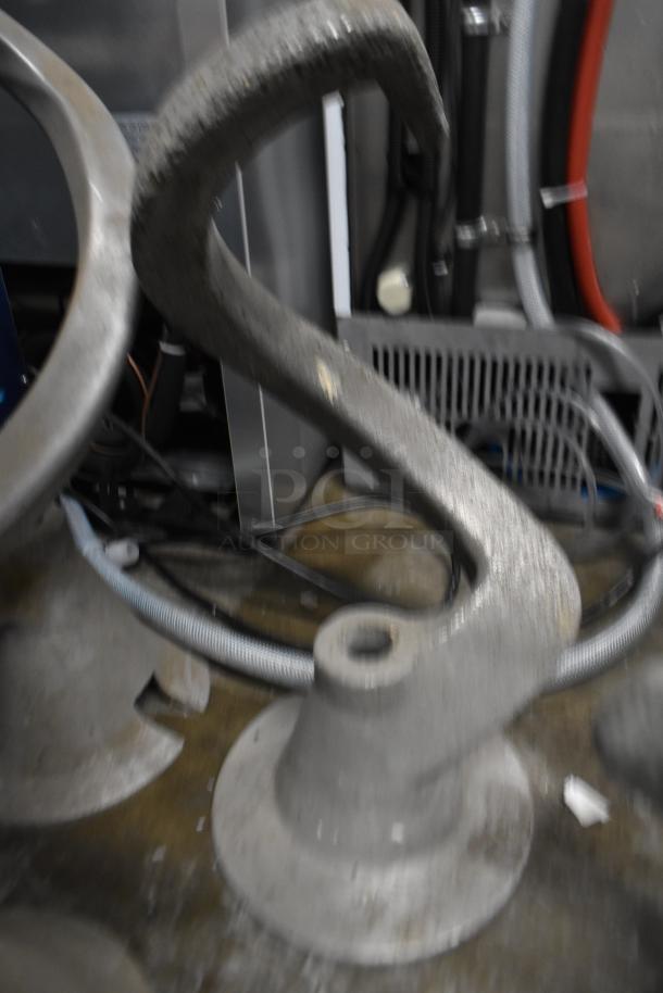 Eight items including three mixing bowls, five dough hook attachments for Hobart mixer. Used condition, industrial setting.