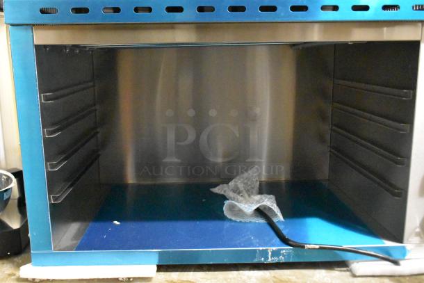 Brand new Avantco 177CHSME32M 32" cheese melter, stainless steel, with steel racks and slight cosmetic damage, 208/240V.