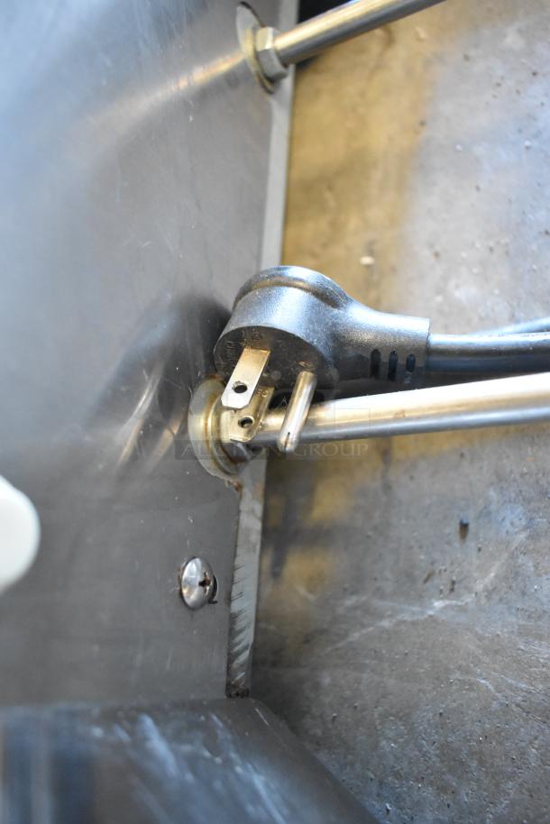 Stoelting stainless steel soft serve ice cream machine, features a drink mixing attachment, close-up of power cord connection.