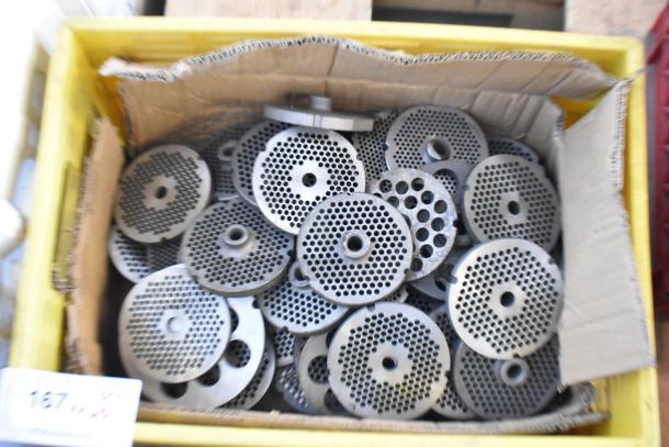 Box of 63 metal grinder plates, used for meat grinders, in varied condition. Circular with perforated designs.