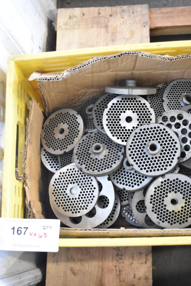 Box of 63 metal plates for meat grinders, various sizes and patterns, in used condition. Auction lot label visible.