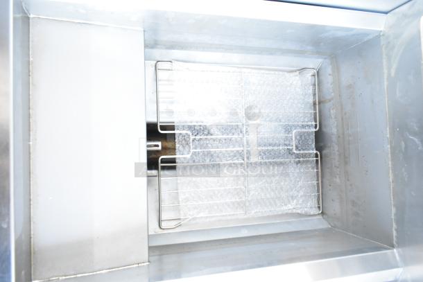 BRAND NEW Frymaster FPPH255CSE deep fryer interior, featuring a metal fry basket and bubble wrap, commercial-grade quality.