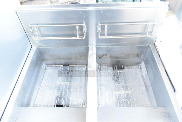 Brand new Frymaster FPPH255CSE propane deep fryer with 4 metal baskets and filtration system, on casters, 80,000 BTU.