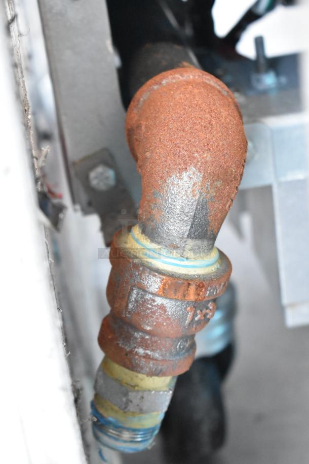 Close-up of a rusted pipe elbow connection on a Frymaster FPPH255CSE commercial fryer, showing detailed wear.