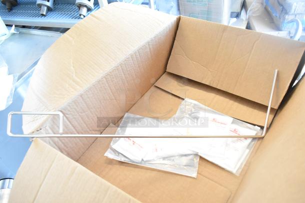 Cardboard box containing Frymaster fryer accessory and sealed instruction packets.