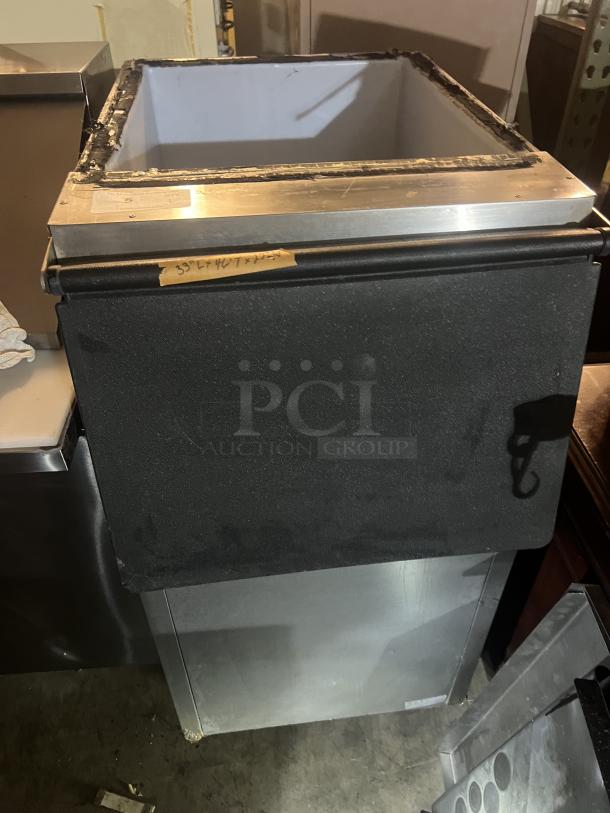 Stainless steel ice holding bin, dimensions 22x33x46, features a black insulated exterior and open top. Visible wear on edges.