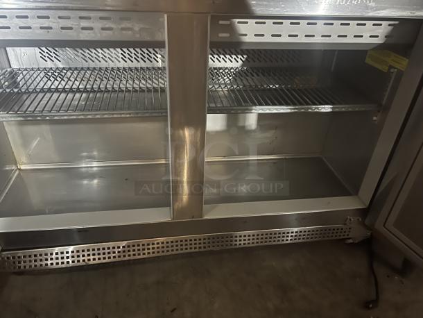 Berg stainless steel prep table, model EDMT-48 18 BERG, 48x34.5x47 inches, 120v, shelves visible, excellent condition.