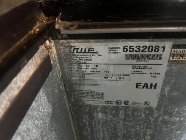 True Underbar Bottle Cooler label, model TD-50-18. Serial 6532081. Refrigerant R134A. Dimensions 49-¾"x27"x33-½".