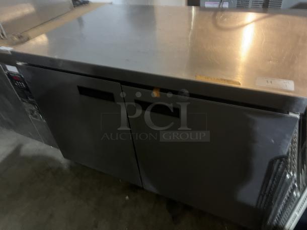 Stainless steel two-door refrigerator prep table with worktop, 48x34x32 inches, commercial grade, good condition.