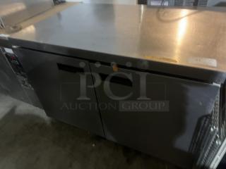 Stainless steel two-door refrigerator prep table with worktop, 48x34x32 inches, commercial grade, good condition.