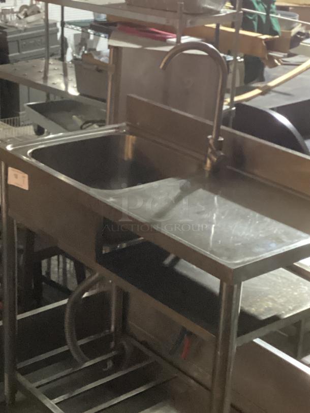 Stainless steel single sink work station, 39-½" x 20" x 35-3/4", with faucet and storage shelf. Good condition.