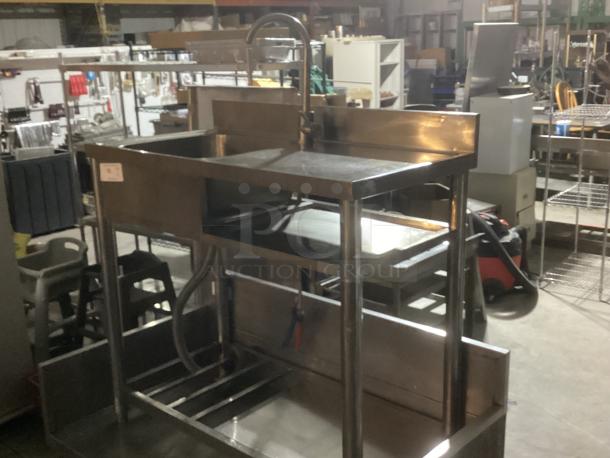 Stainless steel single sink work station, 39-½" x 20" x 35-3/4". Features faucet and backsplash, sturdy condition, ideal for commercial use.
