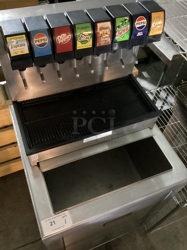 Stainless steel soda machine with ice bin, 7 dispensers, 25x25x54 inches, good condition, visible drink logos include Pepsi and Crush.