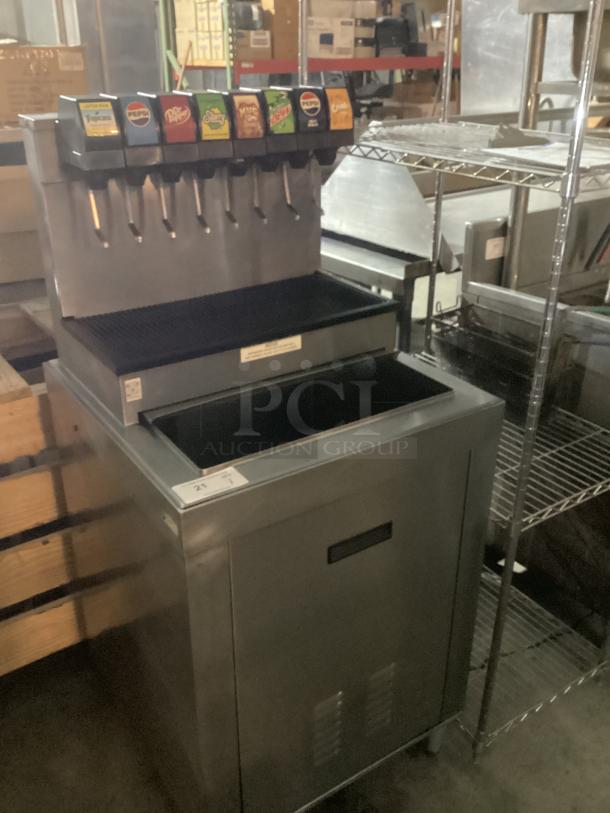 Stainless steel soda machine with ice bin, 25x25x54, six dispensers, good condition, labeled for various drinks.
